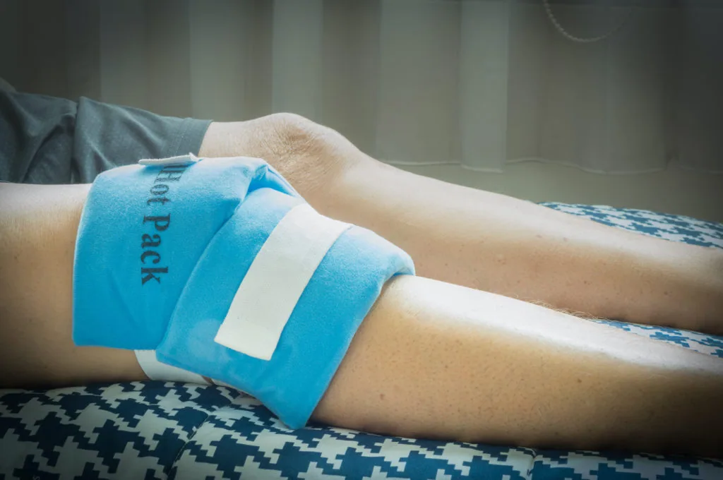 Person's arm wrapped with blue gel ice pack for pain relief and swelling reduction
